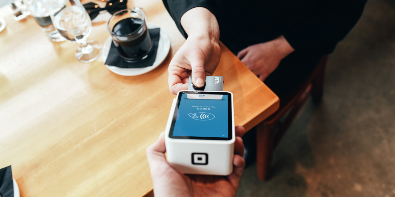 Square payment reader at restaurant table