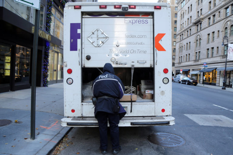 FedEx Express driving making deliveries in Manhattan during holiday season